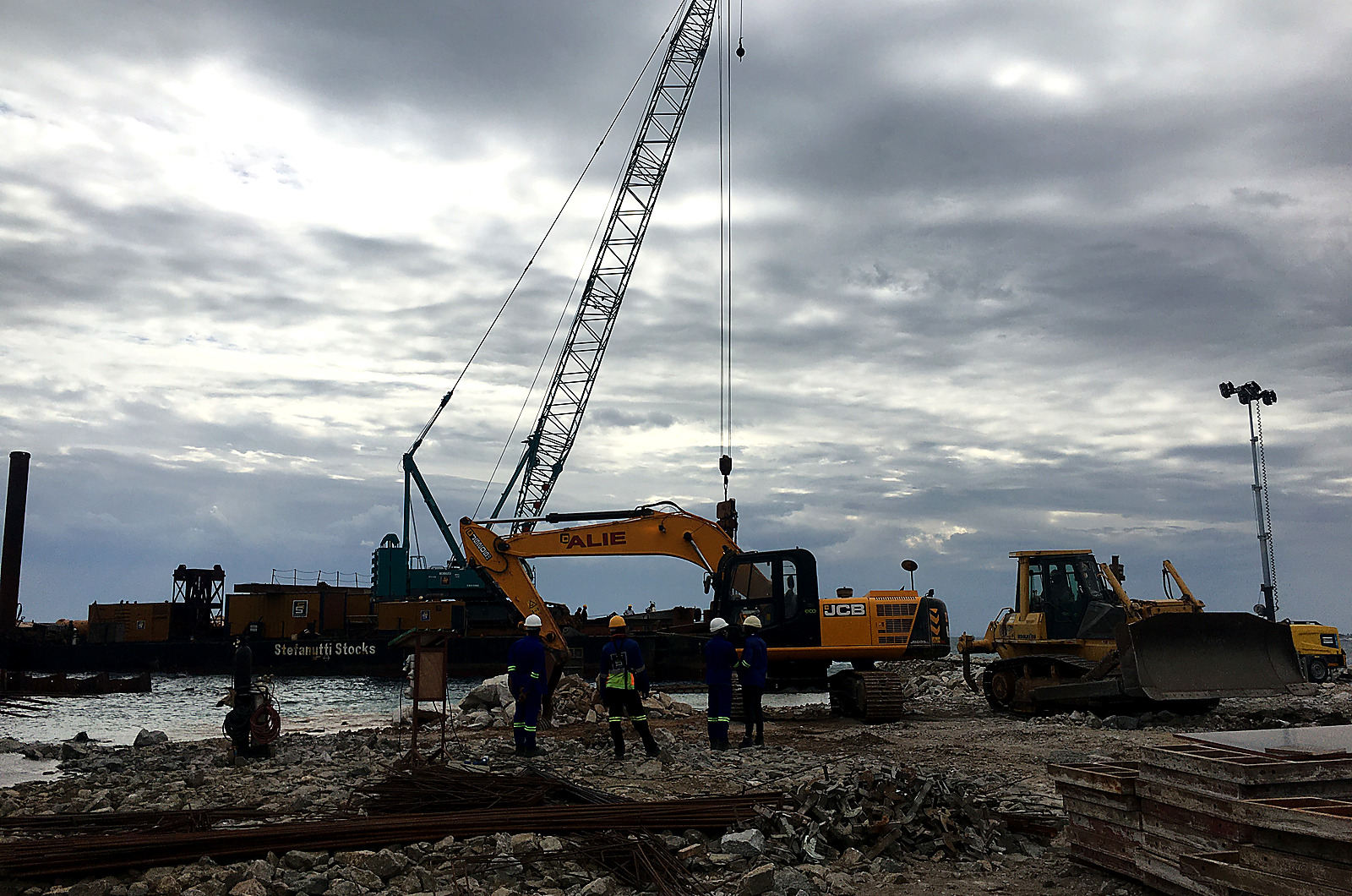 ALIE crane and earthmoving equipment working on a project site