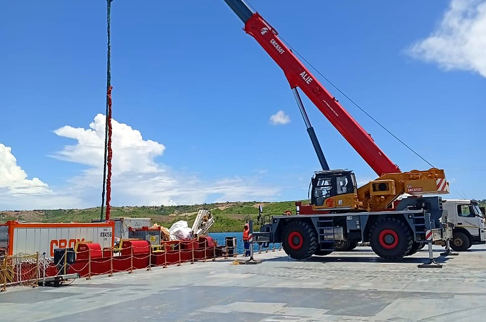 ALIE red crane lifting cargo on a project site